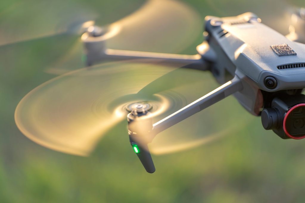 Close image of a drone with propellers spinning